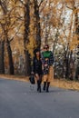 Two cozy smiling young girls walk at autumn park road Royalty Free Stock Photo