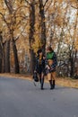 Two cozy smiling young girls walk at autumn park road Royalty Free Stock Photo