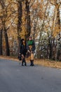 Two cozy smiling young girls walk at autumn park road Royalty Free Stock Photo