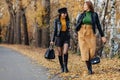 Two cozy young girls walk at autumn park road an make photos Royalty Free Stock Photo