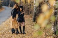 Two cozy young girls walk at autumn park road an make photos Royalty Free Stock Photo