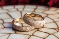 two cracked wedding rings on a cracked ceramic plate