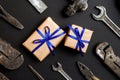Two craft gifts with vintage old tools on black paper background. Fathers day concept. Flat lay Royalty Free Stock Photo