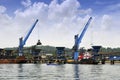 Two crane unloading coal from barge to hopper