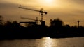 Two cranes in the sunset, in the front the river port MÃÂ¼hlheim
