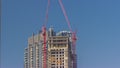 Two cranes working on constraction site works of new skyscraper timelapse Royalty Free Stock Photo