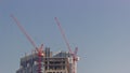 Two cranes working on constraction site works of new skyscraper timelapse Royalty Free Stock Photo