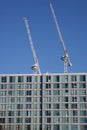 Two cranes working on a skyrise building on Avebury Boulevard in Milton Keynes, Buckinghamshire in the UK