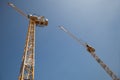 Two cranes working in tandem on a construction site in the UK