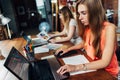 Two creative female graphic designers working on laptop at office Royalty Free Stock Photo