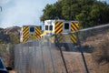 Two crew transport trucks from Ventura County Fire Department arrive at the scene of a brush fire