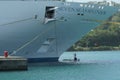 Two crewmembers painting white bow of cruise passenger vessel in port of Castries, St Lucia. Royalty Free Stock Photo