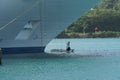 Two crewmembers are painting white the bow of cruise passenger vessel in port of Castries, St Lucia. Royalty Free Stock Photo