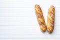 Two crispy fresh baguettes on white table Royalty Free Stock Photo