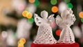 Two crocheted xmas angels decorations on blinking lights background