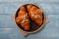 Two croissant with almonds on blue wooden background Royalty Free Stock Photo