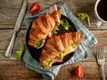 Two croissant sandwiches on wooden table Royalty Free Stock Photo