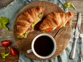 Two croissant sandwiches on wooden table Royalty Free Stock Photo