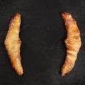 Two croissants on a black background, shot from the top, forming a frame Royalty Free Stock Photo