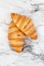 Two Croissants over a Marble Background Royalty Free Stock Photo