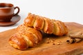 Two croissants on a wooden board Royalty Free Stock Photo