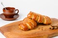 Two croissants on a wooden board Royalty Free Stock Photo