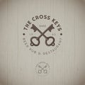 Cross keys pub logo. Berr pub emblem. Two keys with letters emblems on a wood background.