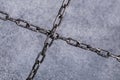 Two crossed chains on gray