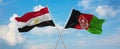 two crossed flags Afghanistan and Egypt waving in wind at cloudy sky. Concept of relationship, dialog, travelling between two
