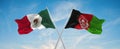 two crossed flags Afghanistan and mexico waving in wind at cloudy sky. Concept of relationship, dialog, travelling between two