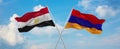 two crossed flags Armenia and Egypt waving in wind at cloudy sky. Concept of relationship, dialog, travelling between two