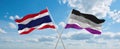 two crossed flags asexuality Pride and Thailand waving in wind at cloudy sky. Concept of relationship, dialog, travelling between