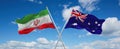 two crossed flags Australia and Iran waving in wind at cloudy sky. Concept of relationship, dialog, travelling between two
