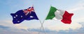 two crossed flags Australia and Italy waving in wind at cloudy sky. Concept of relationship, dialog, travelling between two