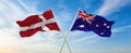 two crossed flags denmark and Australia waving in wind at cloudy sky. Concept of relationship, dialog, travelling between two