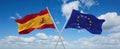 two crossed flags The European Union and spain waving in wind at cloudy sky. Concept of relationship, dialog, travelling between Royalty Free Stock Photo