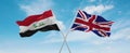 two crossed flags Great Britain and Iraq waving in wind at cloudy sky. Concept of relationship, dialog, travelling between two