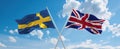 two crossed flags Great Britain and Sweden waving in wind at cloudy sky. Concept of relationship, dialog, travelling between two