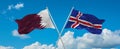two crossed flags Iceland and Qatar waving in wind at cloudy sky. Concept of relationship, dialog, travelling between two
