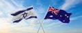 two crossed flags Israel and Australia waving in wind at cloudy sky. Concept of relationship, dialog, travelling between two