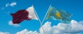 two crossed flags Kazakhstan and Qatar waving in wind at cloudy sky. Concept of relationship, dialog, travelling between two