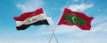 two crossed flags Maldives and Iraq waving in wind at cloudy sky. Concept of relationship, dialog, travelling between two