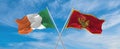 two crossed flags Montenegro and Ireland waving in wind at cloudy sky. Concept of relationship, dialog, travelling between two