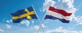 two crossed flags netherlands and Sweden waving in wind at cloudy sky. Concept of relationship, dialog, travelling between two