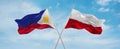 two crossed flags poland and Philippines waving in wind at cloudy sky. Concept of relationship, dialog, travelling between two