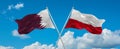 two crossed flags poland and Qatar waving in wind at cloudy sky. Concept of relationship, dialog, travelling between two countries