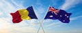two crossed flags romania and Australia waving in wind at cloudy sky. Concept of relationship, dialog, travelling between two
