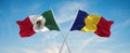 two crossed flags romania and mexico waving in wind at cloudy sky. Concept of relationship, dialog, travelling between two