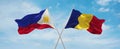 two crossed flags romania and Philippines waving in wind at cloudy sky. Concept of relationship, dialog, travelling between two