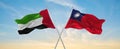 two crossed flags Taiwan and United Arab Emirates waving in wind at cloudy sky. Concept of relationship, dialog, travelling